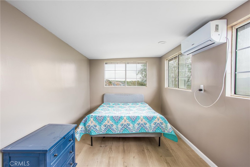 23255 Warren Road San Jacinto, CA 92582 - Photo 19 of 56 a bed sitting in a bedroom next to a window