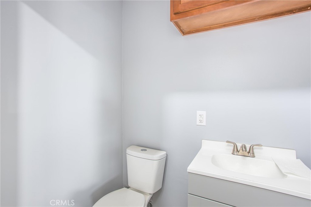 23255 Warren Road San Jacinto, CA 92582 - Photo 21 of 56 a white toilet sitting next to a white sink
