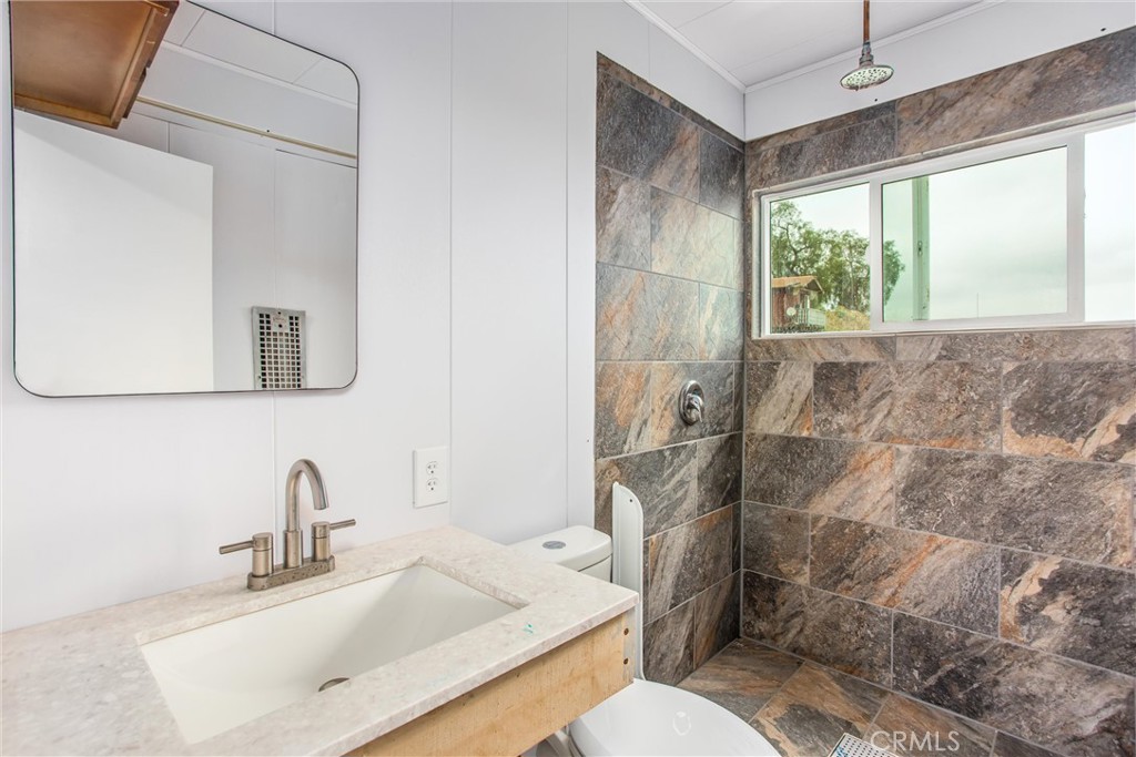 23255 Warren Road San Jacinto, CA 92582 - Photo 26 of 56 a bathroom with a sink toilet and shower