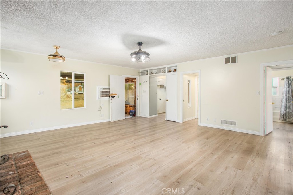 23255 Warren Road San Jacinto, CA 92582 - Photo 31 of 56 a view of an empty room with window and wooden floor