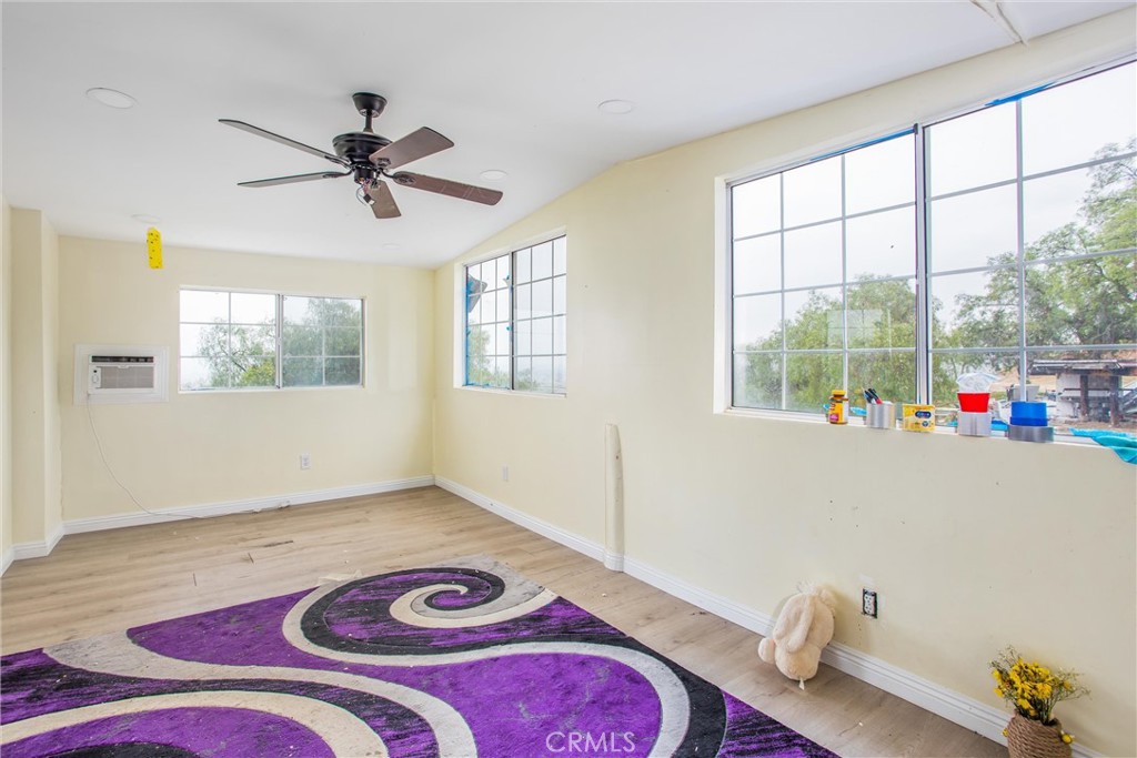 23255 Warren Road San Jacinto, CA 92582 - Photo 36 of 56 a living room with a bed furniture and a window