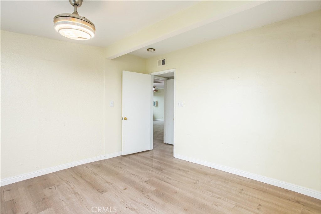 23255 Warren Road San Jacinto, CA 92582 - Photo 38 of 56 a view of an empty room with wooden floor