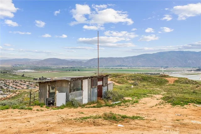 a backyard of a house with large trees and a big yard