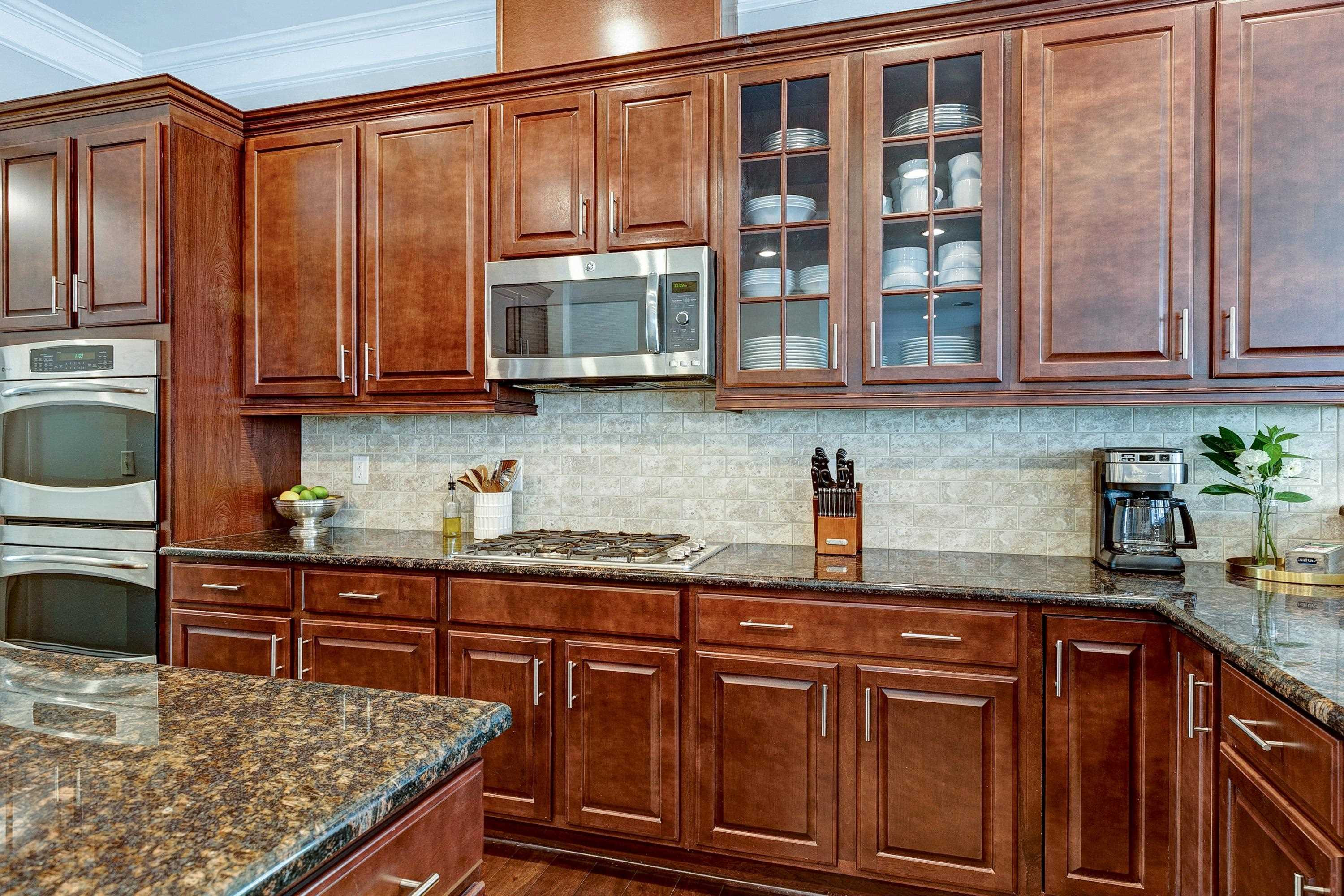 1529 Fullerton Place Raleigh, NC 27607 - Photo 20 of 53 a kitchen with stainless steel appliances granite countertop a sink and cabinets
