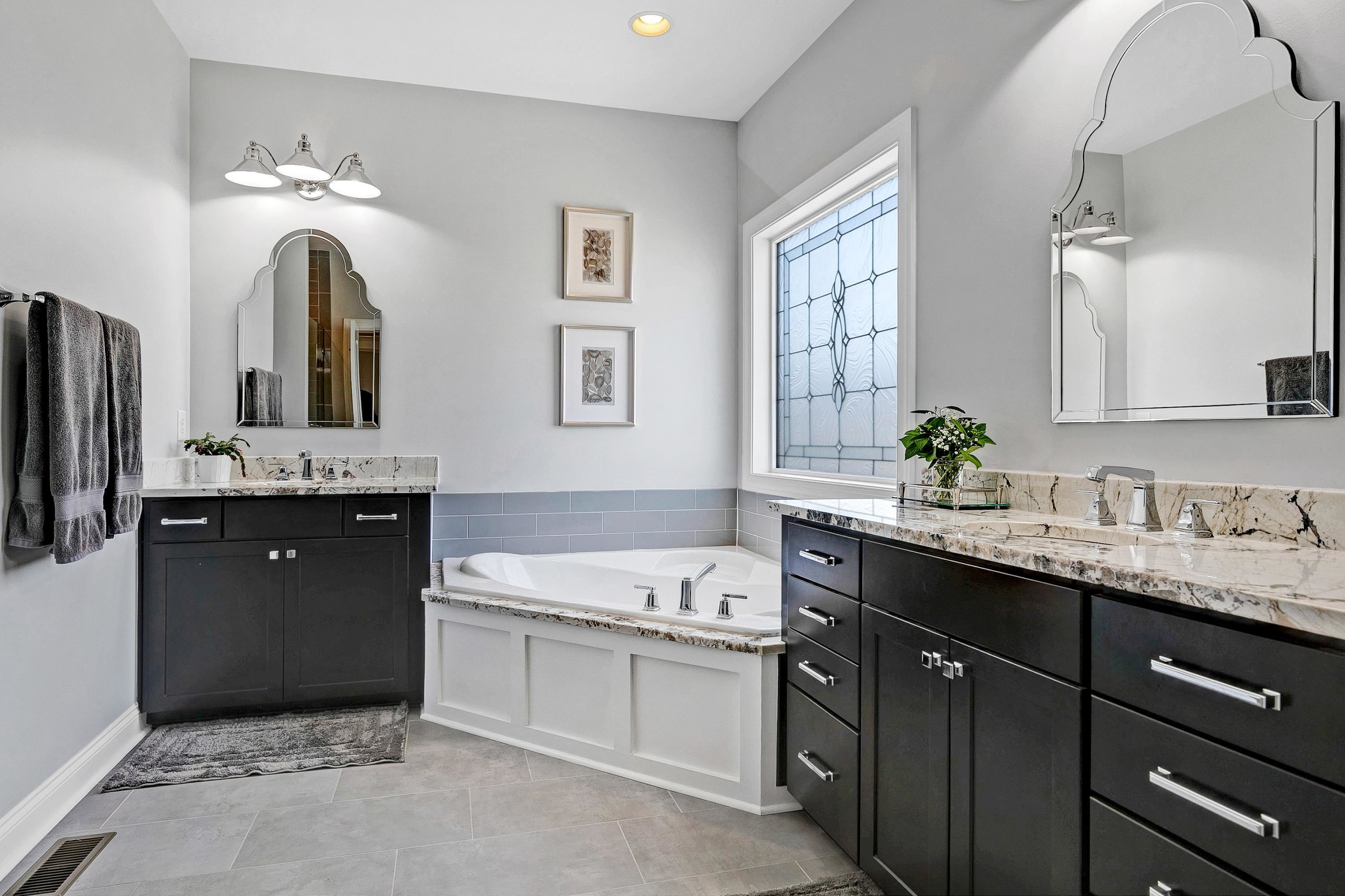 1529 Fullerton Place Raleigh, NC 27607 - Photo 27 of 53 a bathroom with a double vanity sink and mirror with bathtub