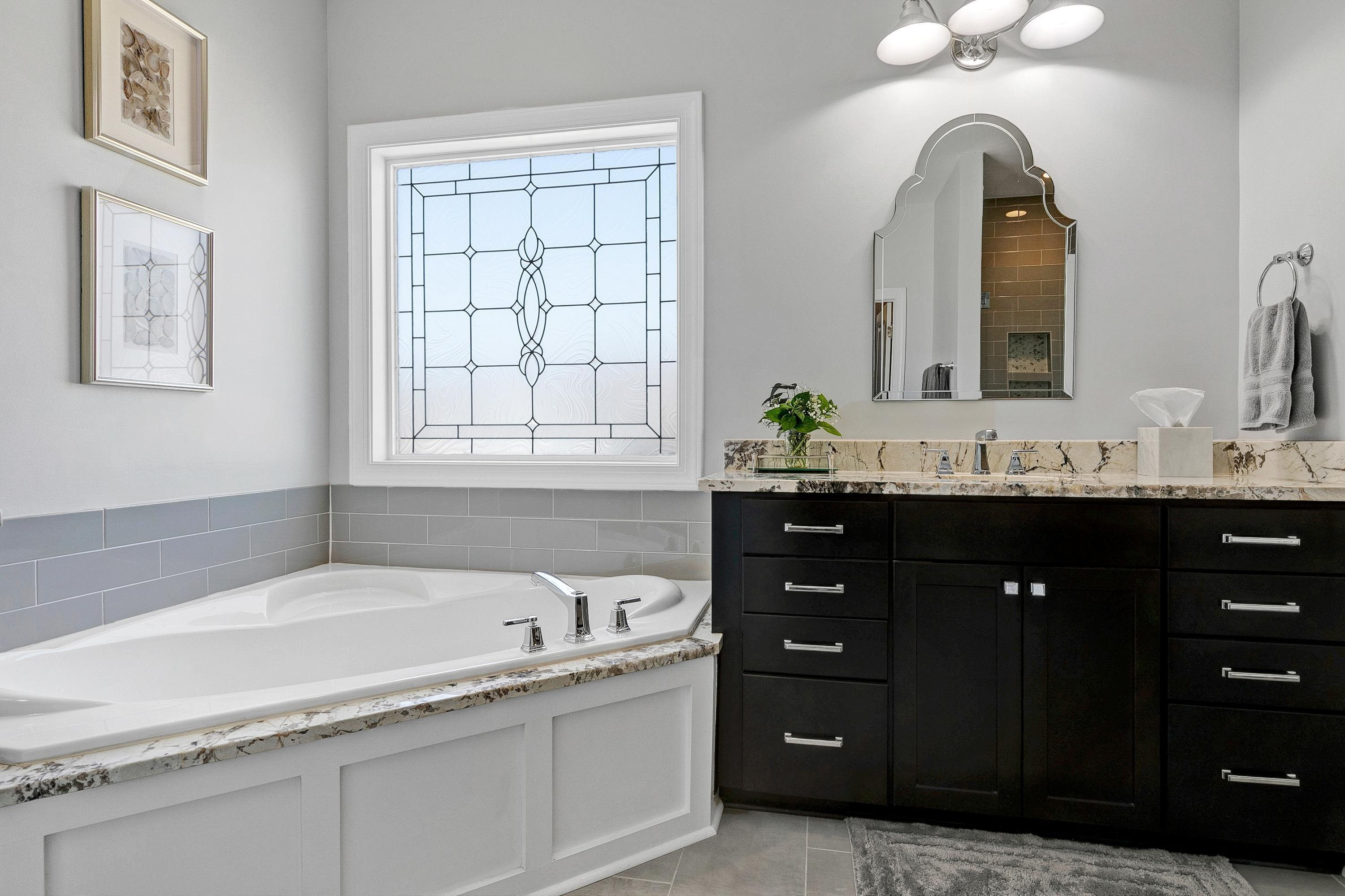 1529 Fullerton Place Raleigh, NC 27607 - Photo 28 of 53 a bathroom with a double vanity sink and a bathtub