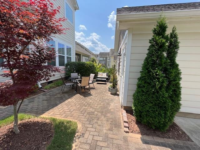 1529 Fullerton Place Raleigh, NC 27607 - Photo 39 of 53 a view of a patio with table and chairs and potted plants