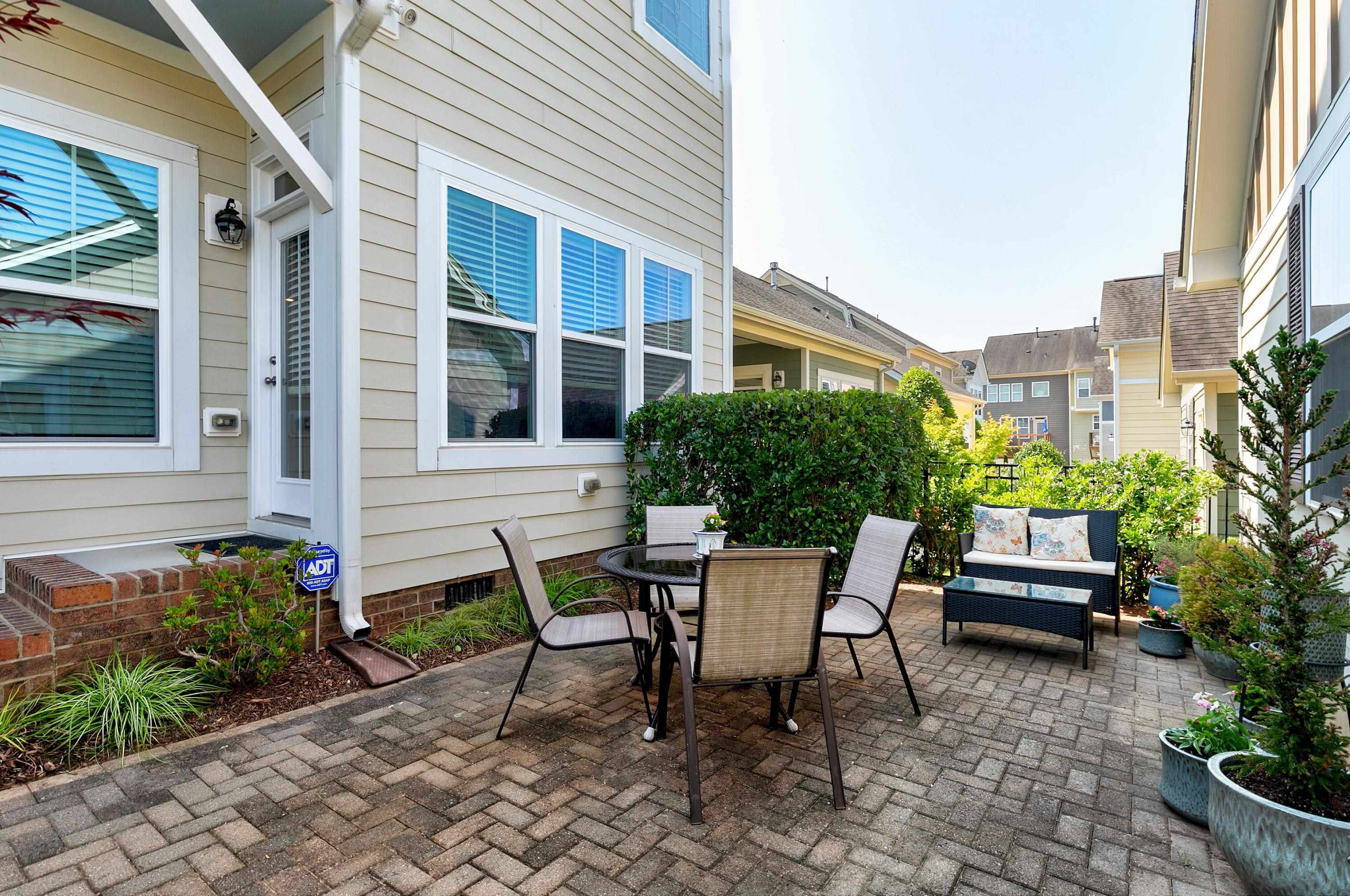 1529 Fullerton Place Raleigh, NC 27607 - Photo 40 of 53 a view of a patio with table and chairs and potted plants