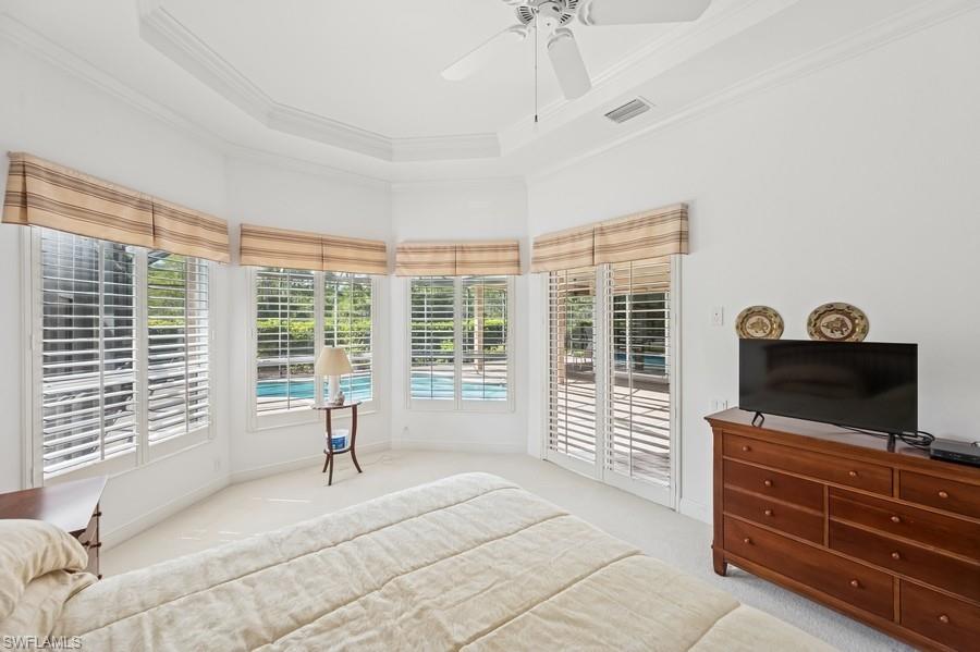7488 Treeline Drive Naples, FL 34119 - Photo 15 of 22 Carpeted bedroom featuring access to exterior, crown molding, a ceiling fan, and a tray ceiling