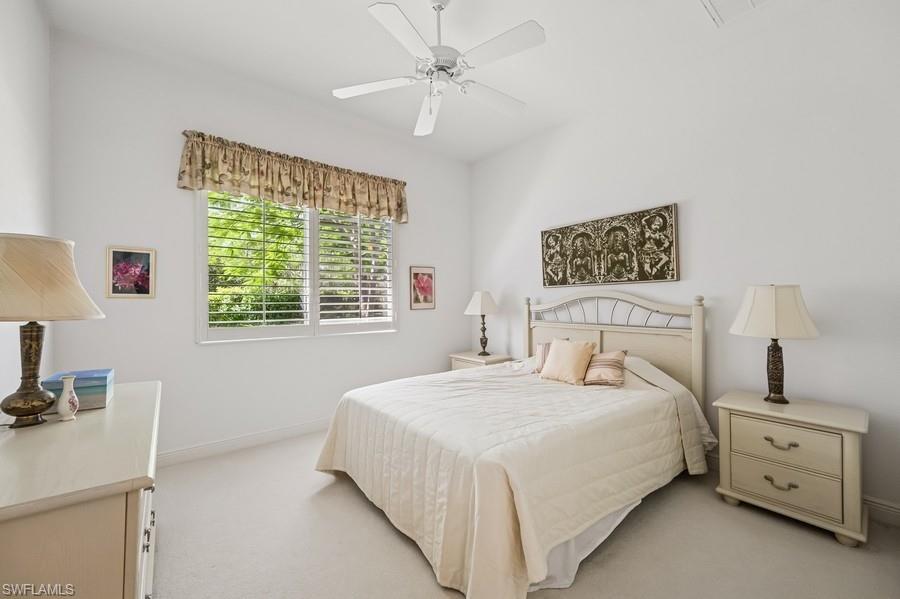 7488 Treeline Drive Naples, FL 34119 - Photo 16 of 22 Bedroom with light colored carpet and ceiling fan