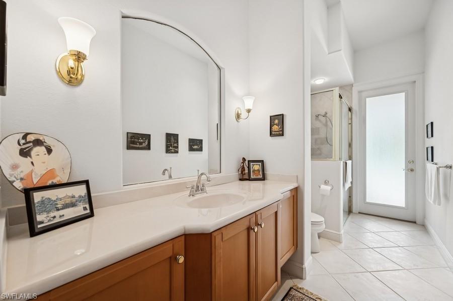 7488 Treeline Drive Naples, FL 34119 - Photo 18 of 22 Full bath featuring vanity, tile patterned flooring, and a shower stall