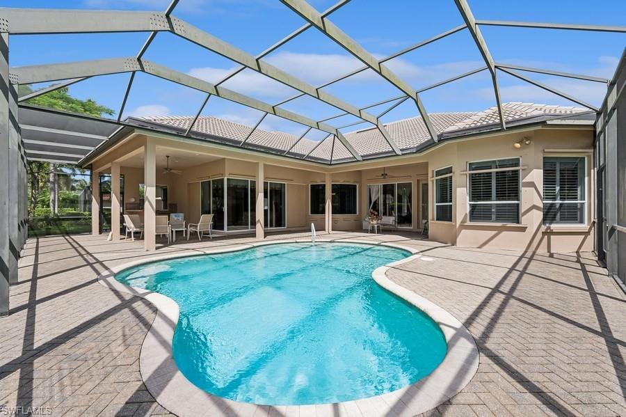 7488 Treeline Drive Naples, FL 34119 - Photo 4 of 22 Swimming pool featuring ceiling fan, a patio, outdoor dining area, and a lanai