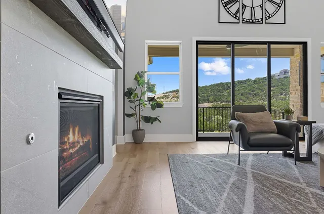 a view of a livingroom with furniture and floor to ceiling window
