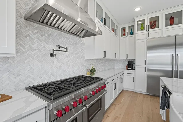 a kitchen with stainless steel appliances granite countertop a stove and a refrigerator