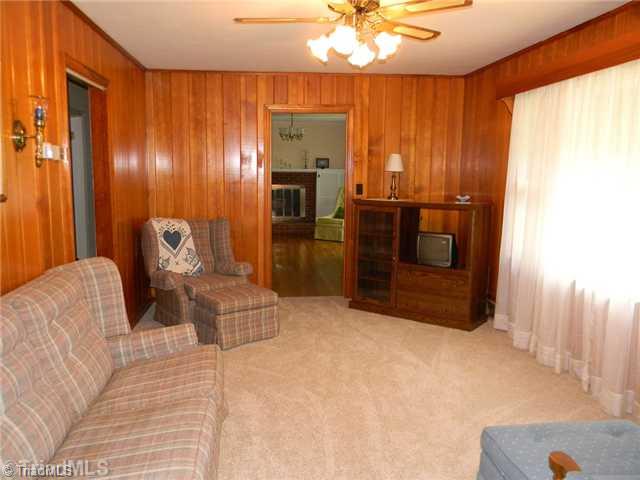 1614 Clingman Road Ronda, NC 28670 - Photo 3 of 12 Den/Family/Great Room. Wood panelled den with large window.
