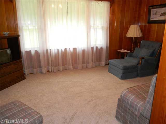 1614 Clingman Road Ronda, NC 28670 - Photo 4 of 12 Den/Family/Great Room. Brand new carpet in the den and dining area of the home.