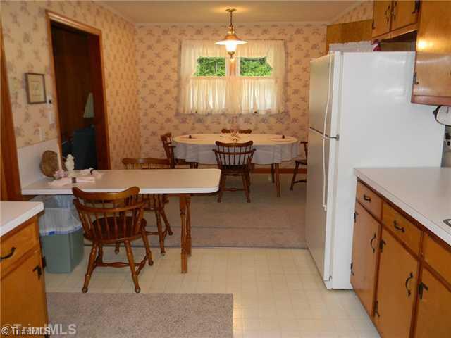 1614 Clingman Road Ronda, NC 28670 - Photo 6 of 12 Dining Room. The home has a combined dining area, eat in bar and kitchen.