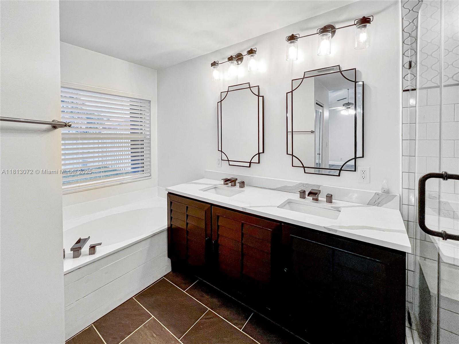 841 Stanton Drive Weston, FL 33326 - Photo 15 of 25 a bathroom with a double vanity sink mirror and bathtub