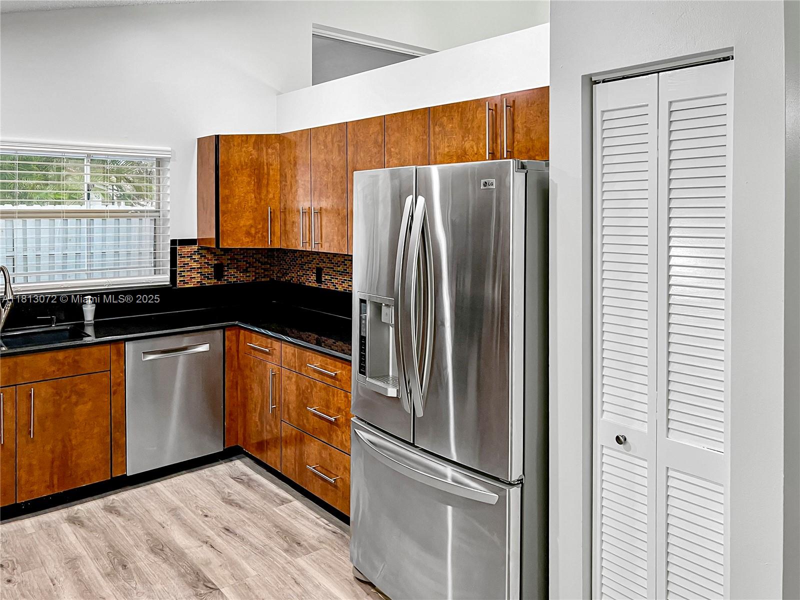 841 Stanton Drive Weston, FL 33326 - Photo 8 of 25 a kitchen with stainless steel appliances granite countertop a refrigerator and a sink