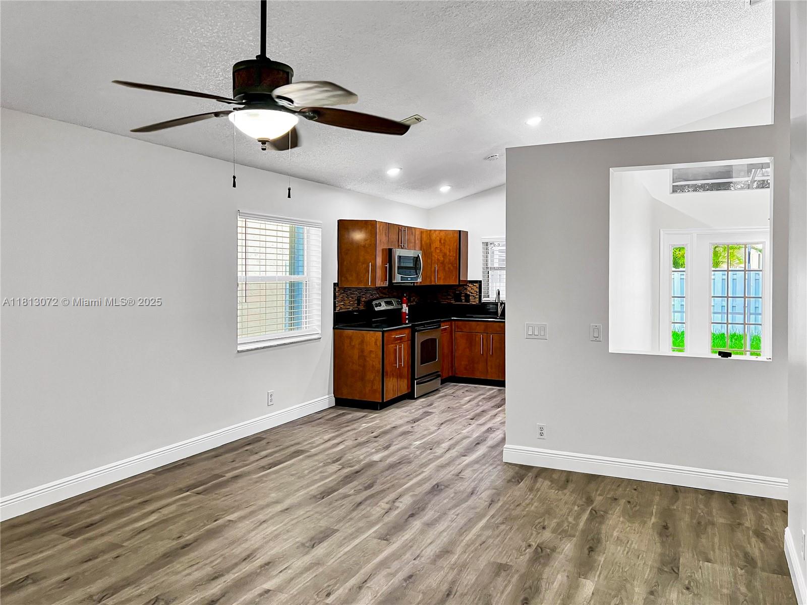 841 Stanton Drive Weston, FL 33326 - Photo 9 of 25 a view of kitchen with sink microwave and refrigerator