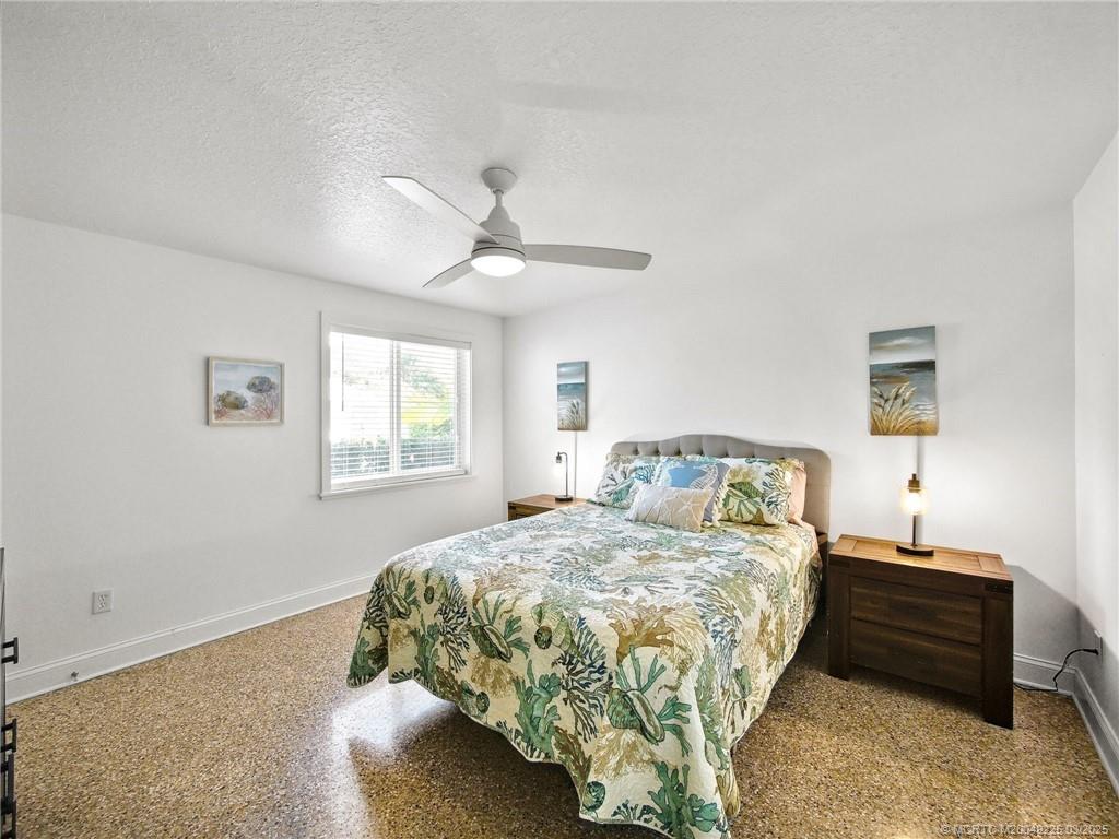 2325 Northwest Fork Road Stuart, FL 34994 - Photo 21 of 27 a bedroom with a bed and a window