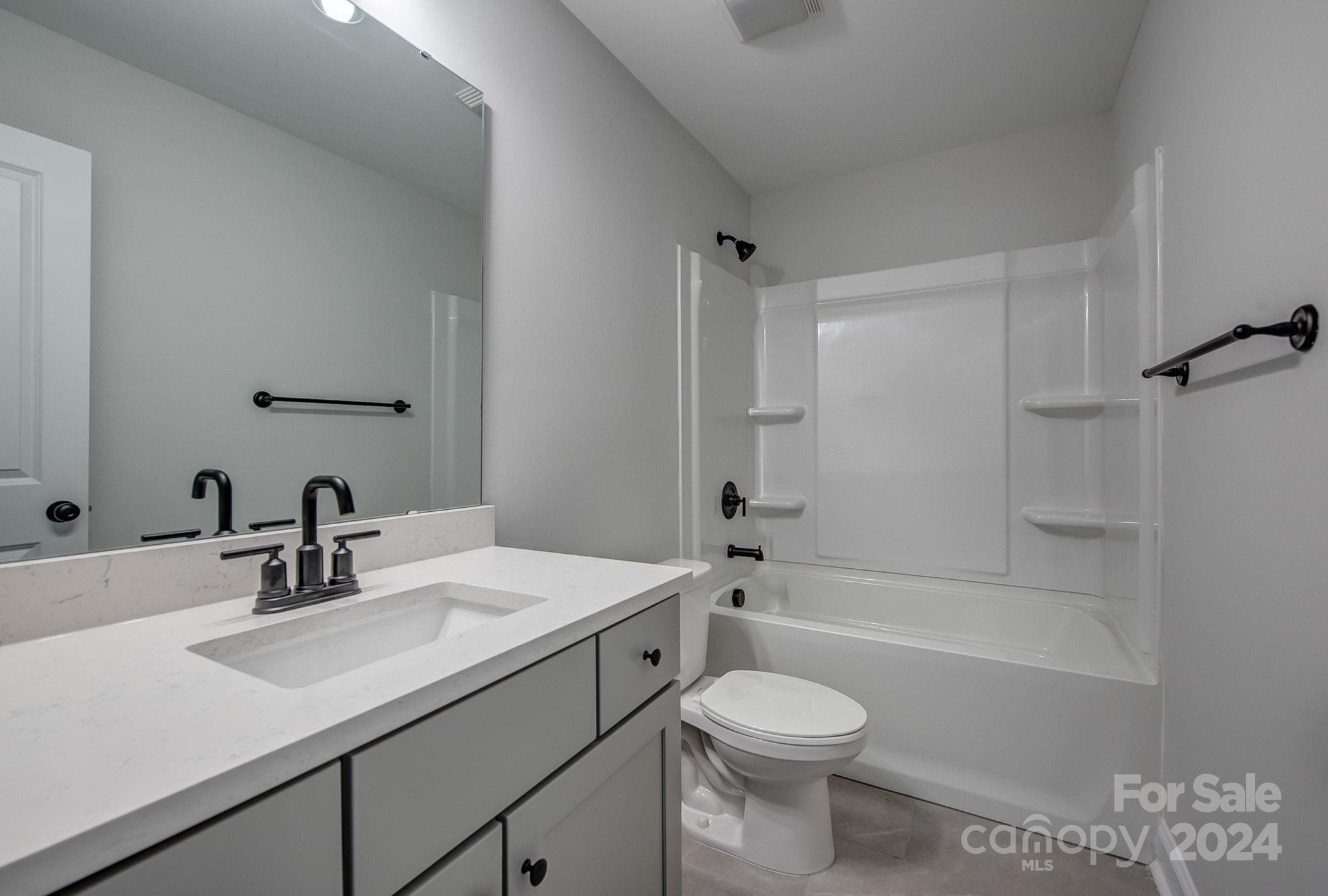 527 Blacksnake Road Stanley, NC 28164 - Photo 19 of 22 a bathroom with a sink a toilet and shower