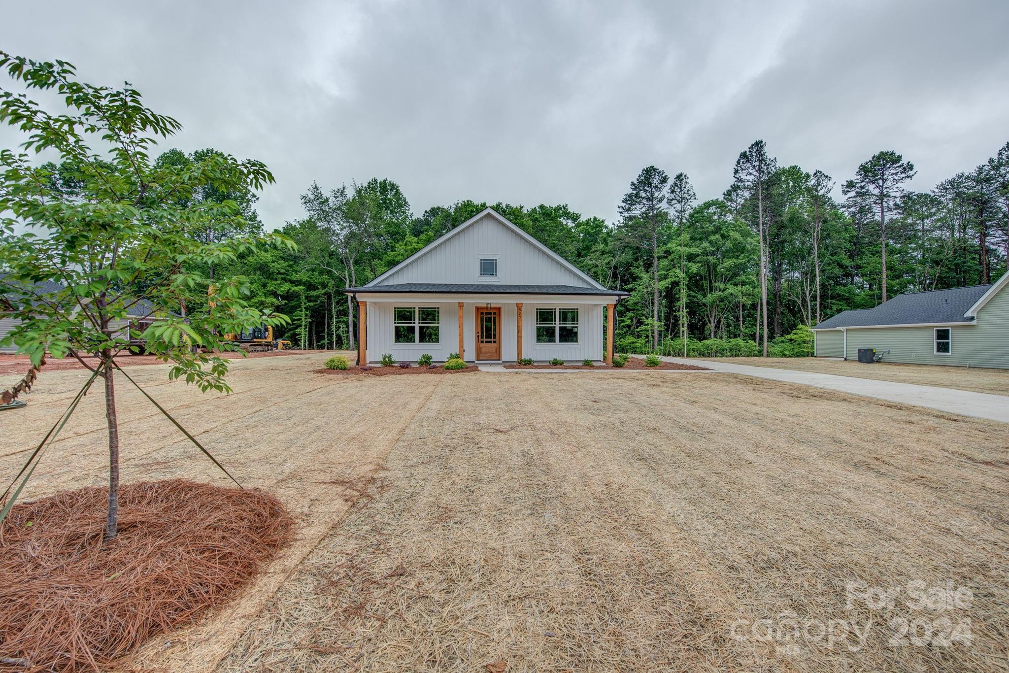 527 Blacksnake Road Stanley, NC 28164 - Photo 2 of 22 a front view of a house with a yard and a garage
