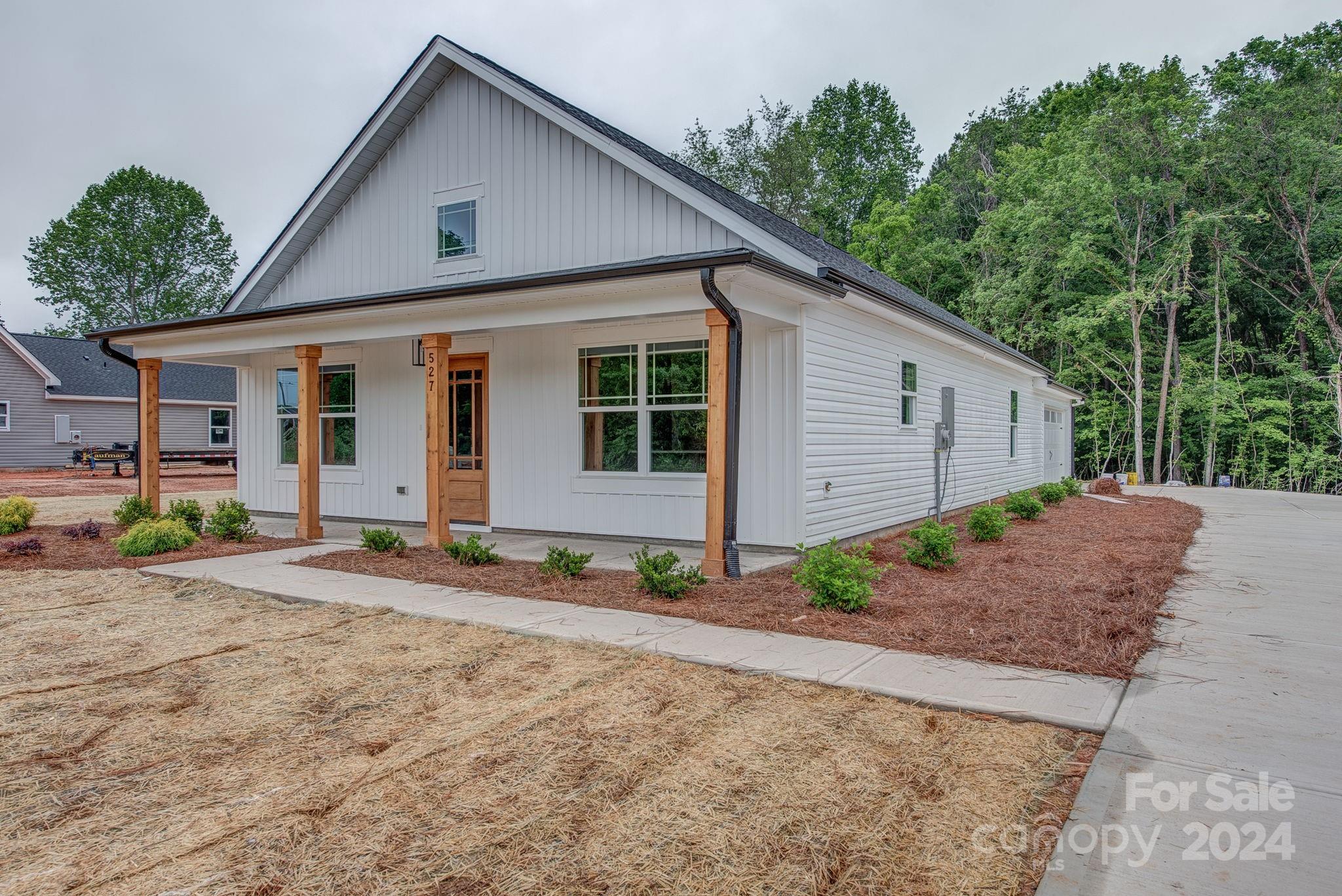 527 Blacksnake Road Stanley, NC 28164 - Photo 4 of 22 a view of a house with a yard and large tree