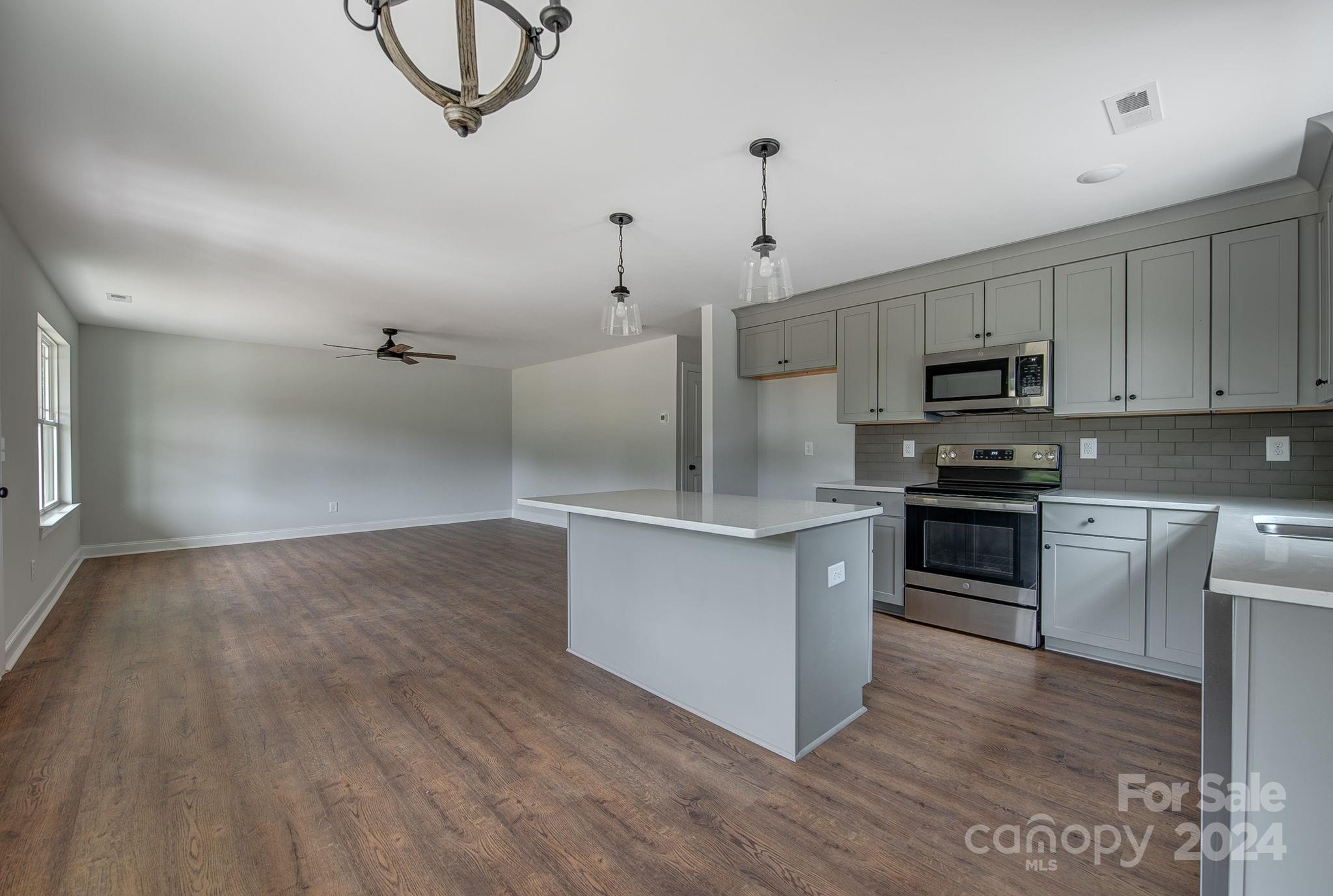 527 Blacksnake Road Stanley, NC 28164 - Photo 10 of 22 a kitchen with stainless steel appliances granite countertop a stove a sink and a refrigerator