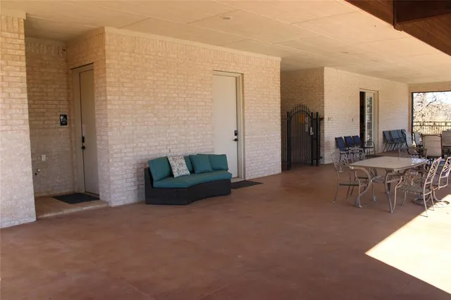 a view of a backyard with table and chairs a fire pit and yard
