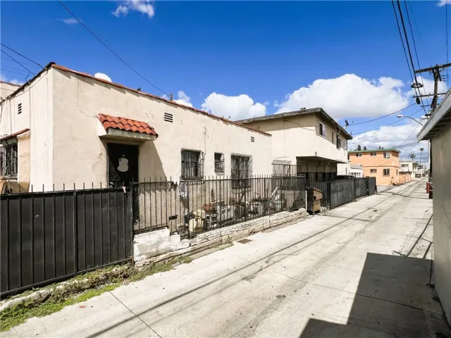 a view of a house with wooden fence