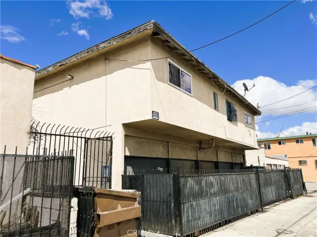 a front view of a house with wooden fence
