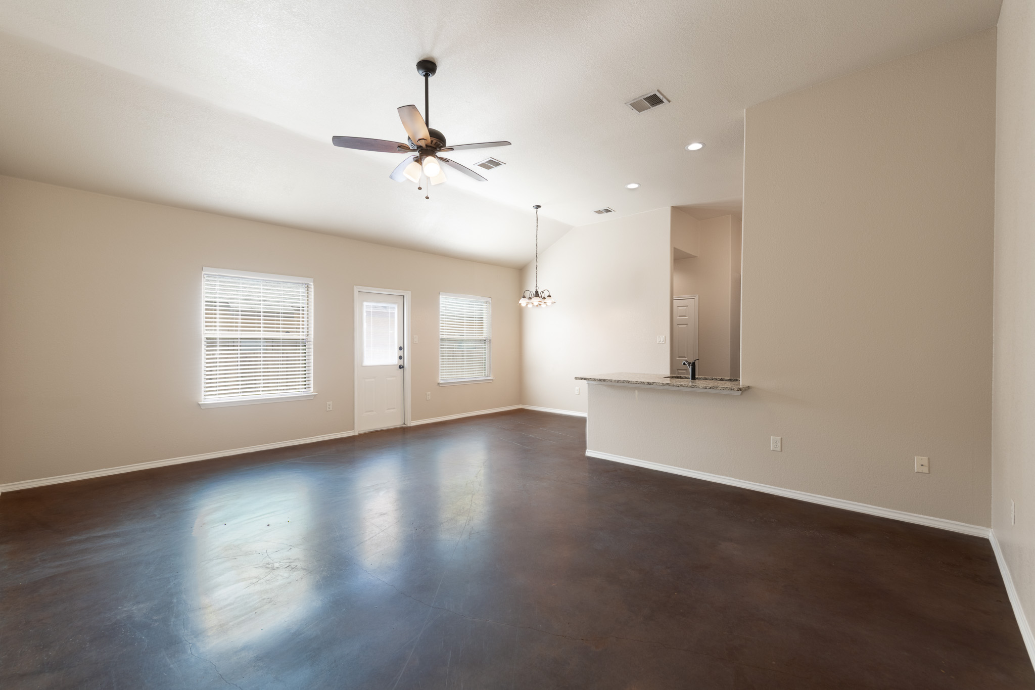 448 Jack Rabbit Lane, Unit A Buda, TX 78610 - Photo 4 of 19 a view of an empty room with wooden floor and a window