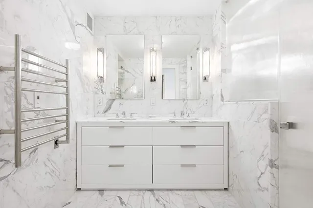 a bathroom with a shower sink and mirror