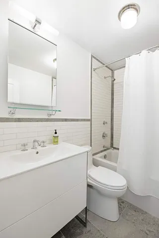 a white toilet sitting next to a bathroom sink