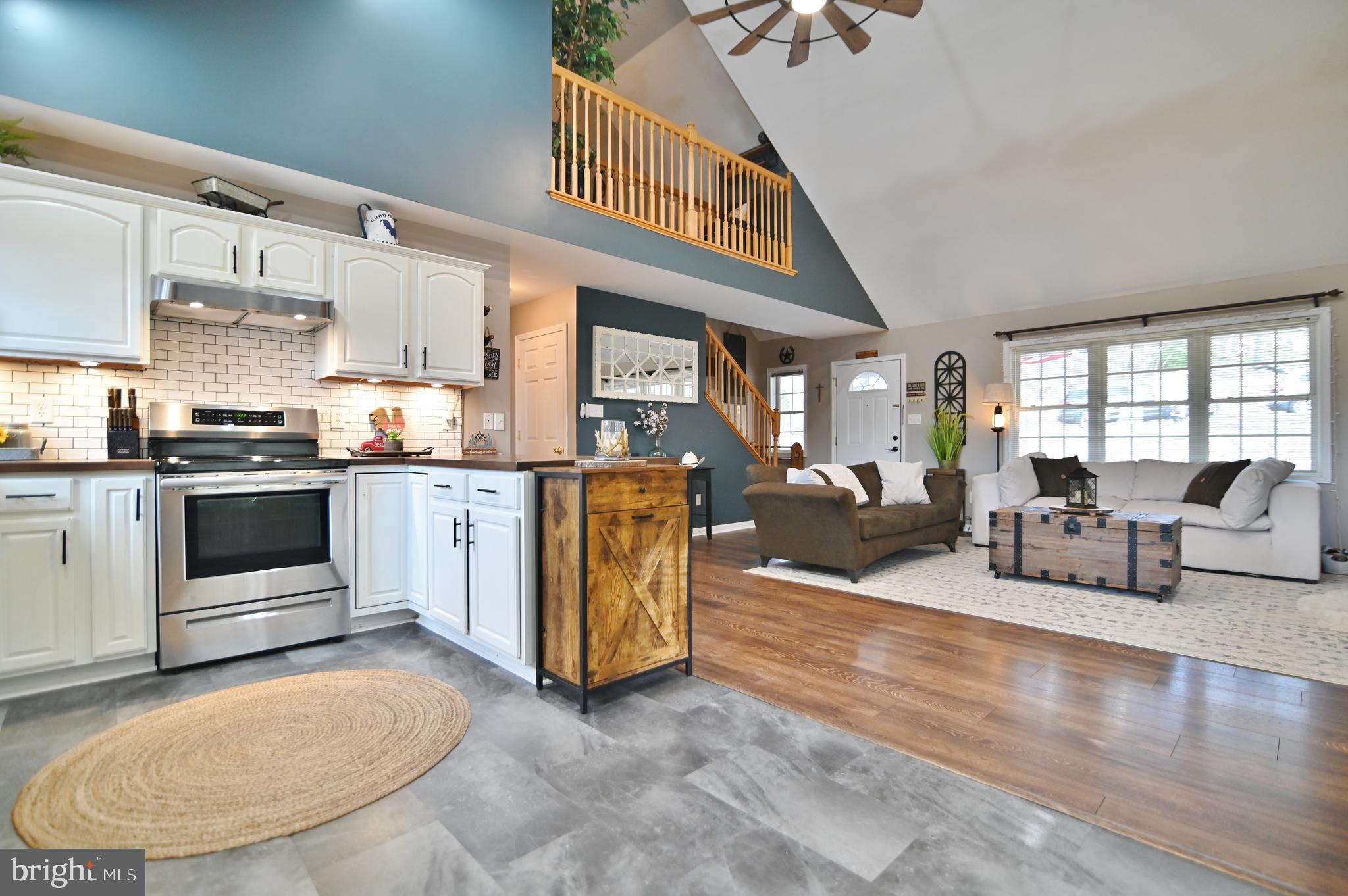 a living room with furniture and a kitchen