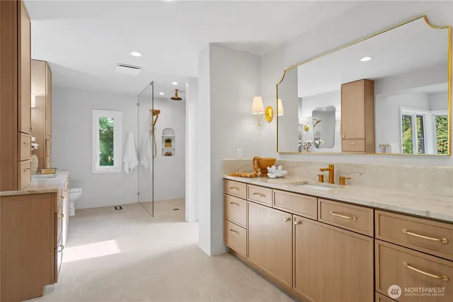 a spacious bathroom with a shower sink and mirror