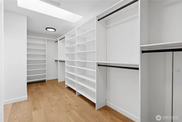 a view of walk in closet with empty racks