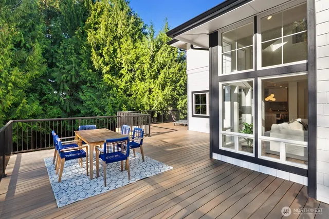 a roof deck view with table and chairs and wooden floor