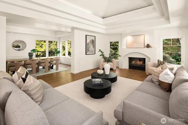 a living room with furniture fireplace and a large window