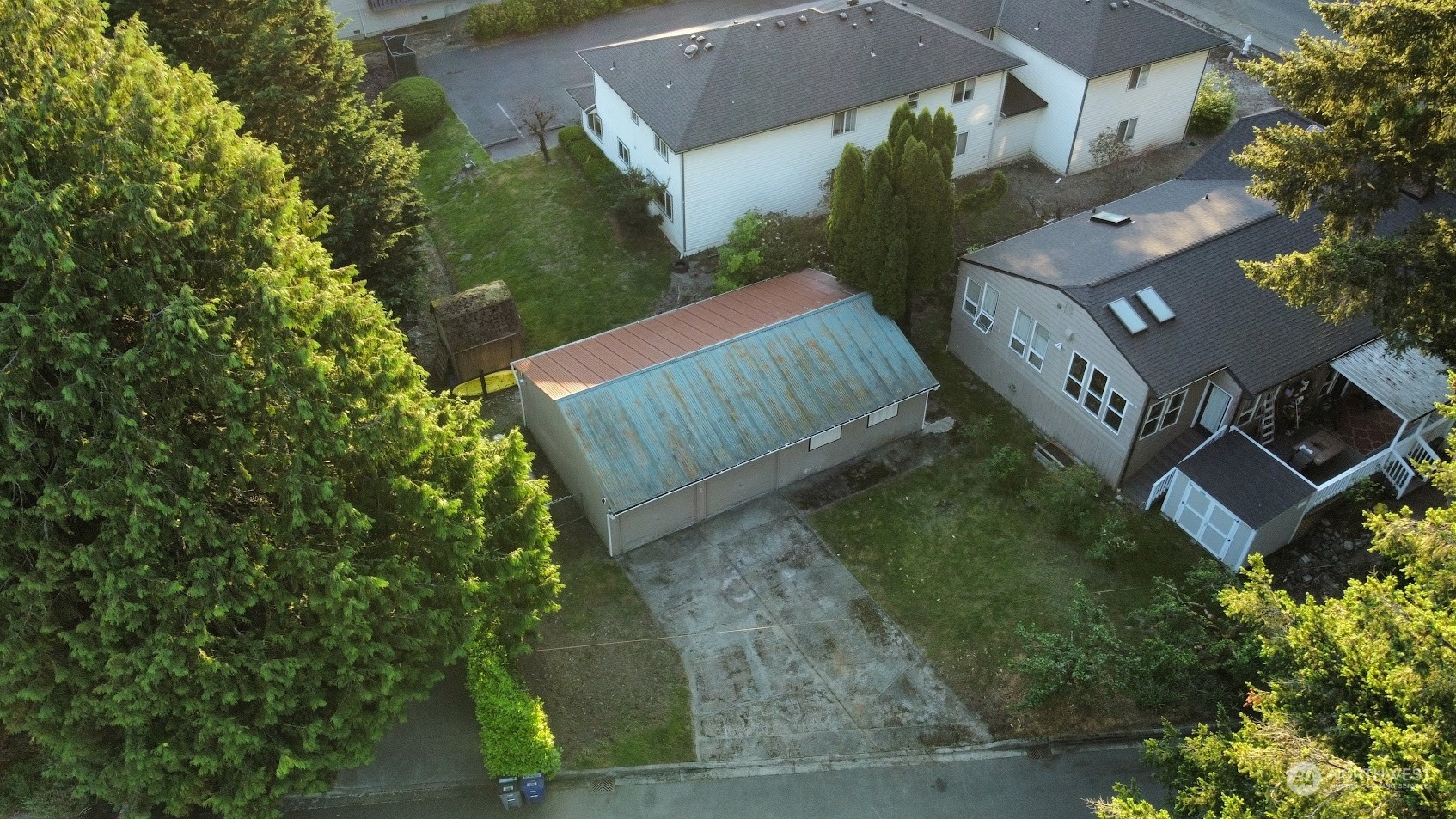 an aerial view of a house with garden space and street view