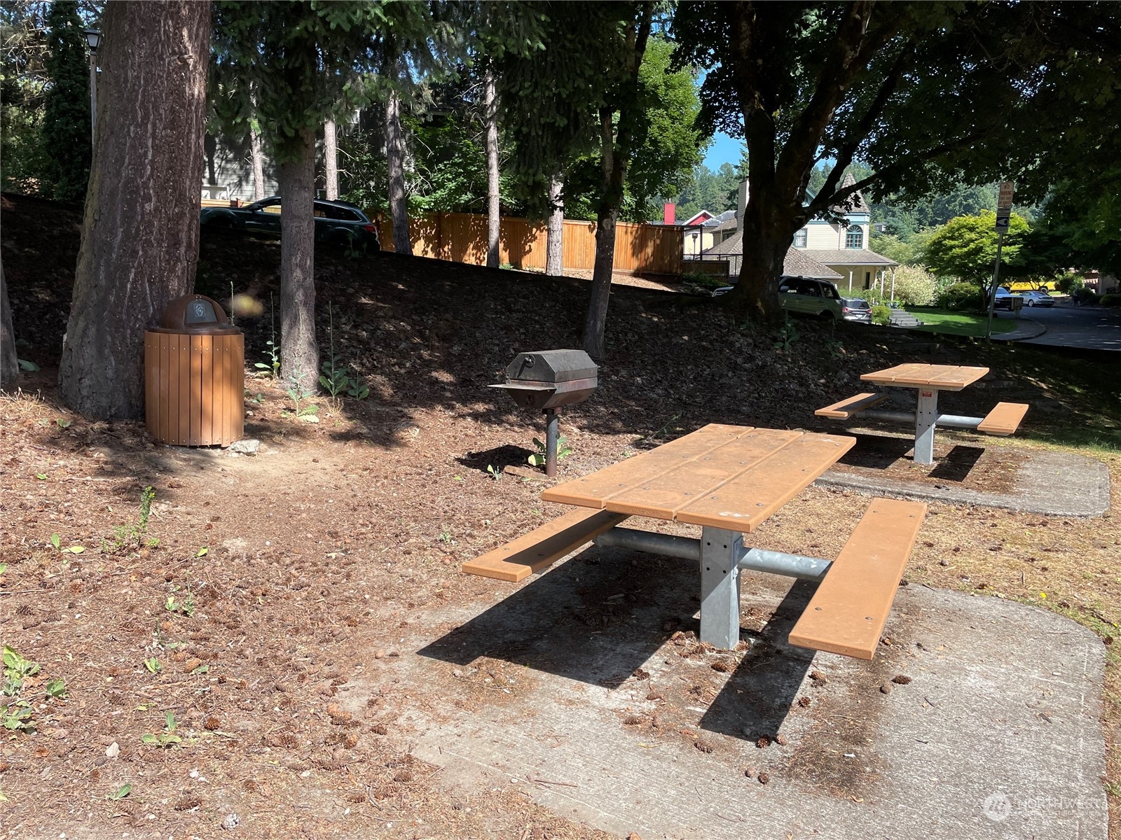17511 113th Avenue Northeast Bothell, WA 98011 - Photo 13 of 14 a view of backyard with a table and chair with wooden fence and trees