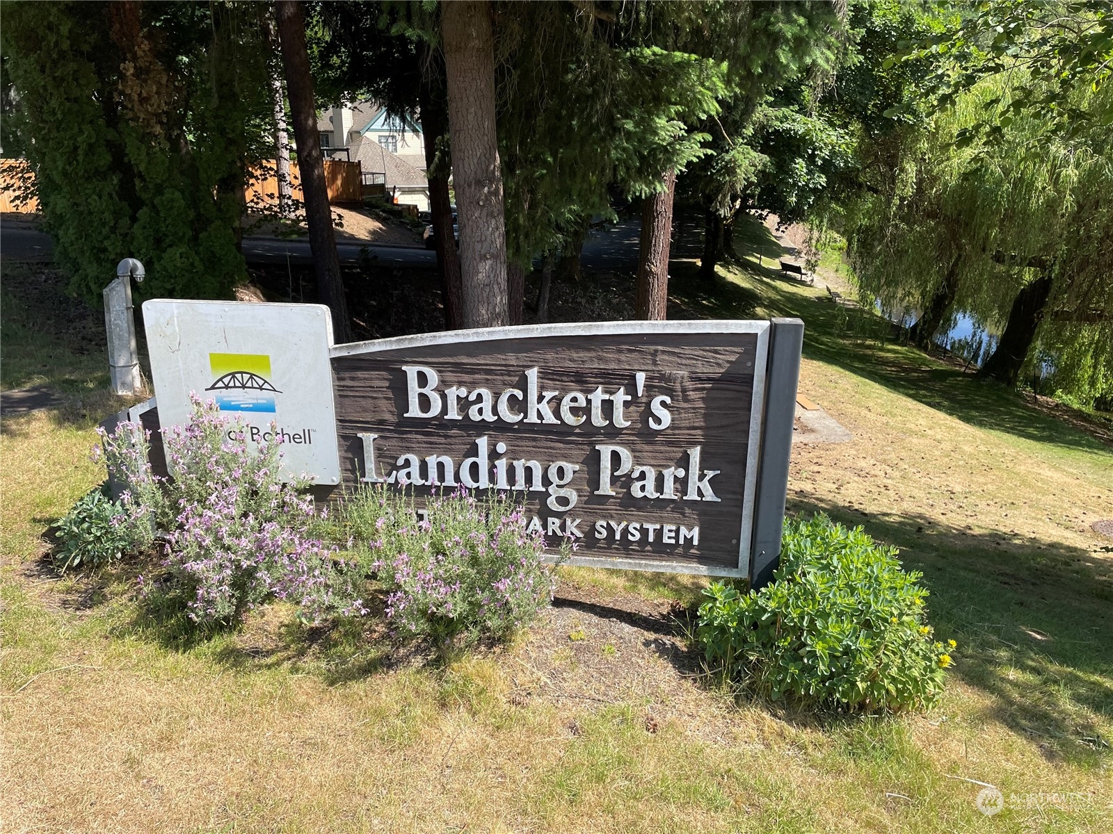 17511 113th Avenue Northeast Bothell, WA 98011 - Photo 10 of 14 a sign broad in front of flowers