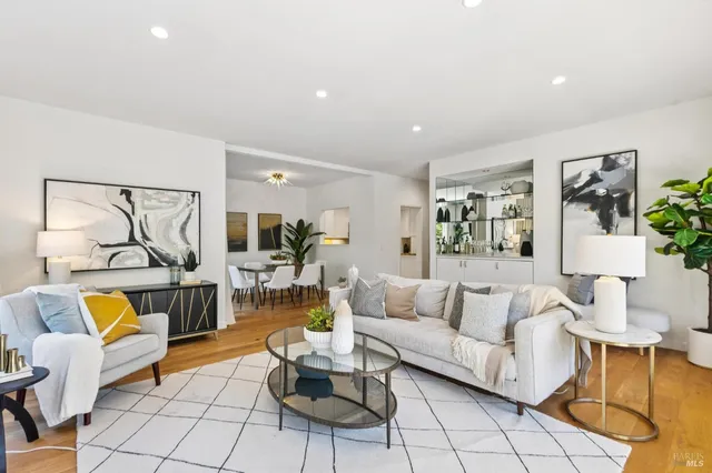a living room with furniture and kitchen view