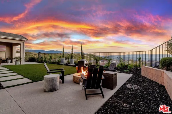a view of a terrace with couches and city view