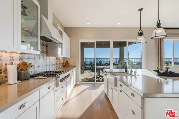 a kitchen with stainless steel appliances granite countertop a sink and stove