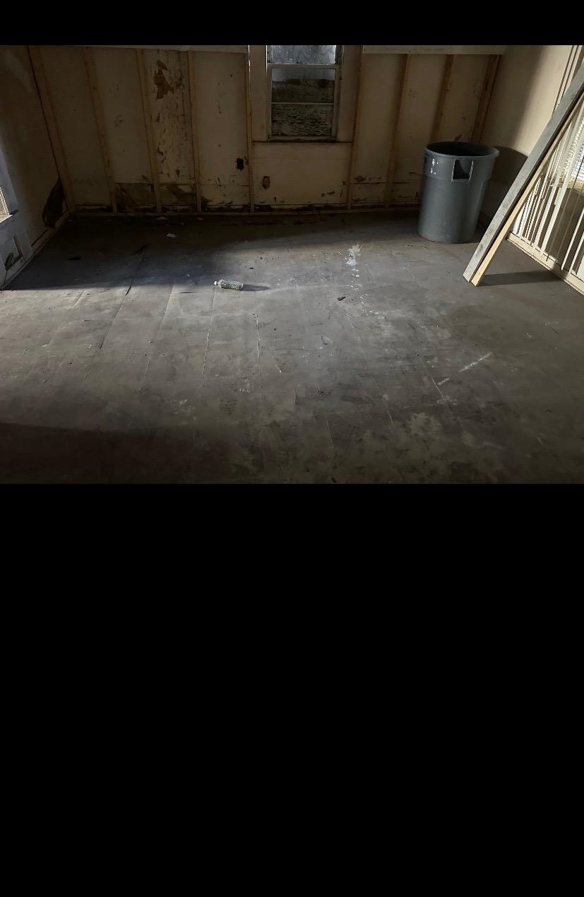 3043 Sax Road Memphis, TN 38109 - Photo 5 of 9 a view of an empty room with a kitchen