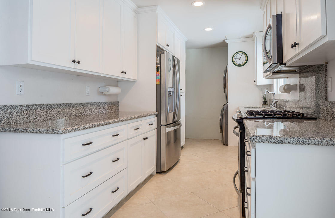 70081 Cobb Road Rancho Mirage, CA 92270 - Photo 11 of 17 a kitchen with granite countertop white cabinets and stainless steel appliances