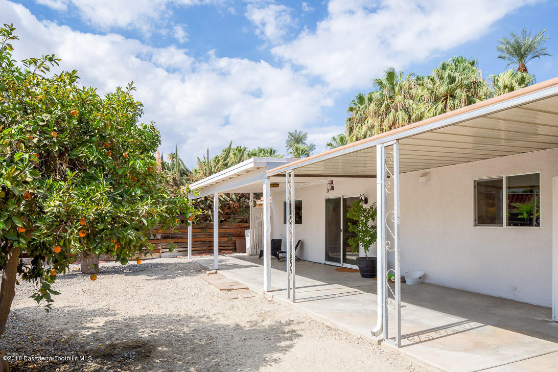 70081 Cobb Road Rancho Mirage, CA 92270 - Photo 15 of 17 a view of a white house with a yard and potted plants