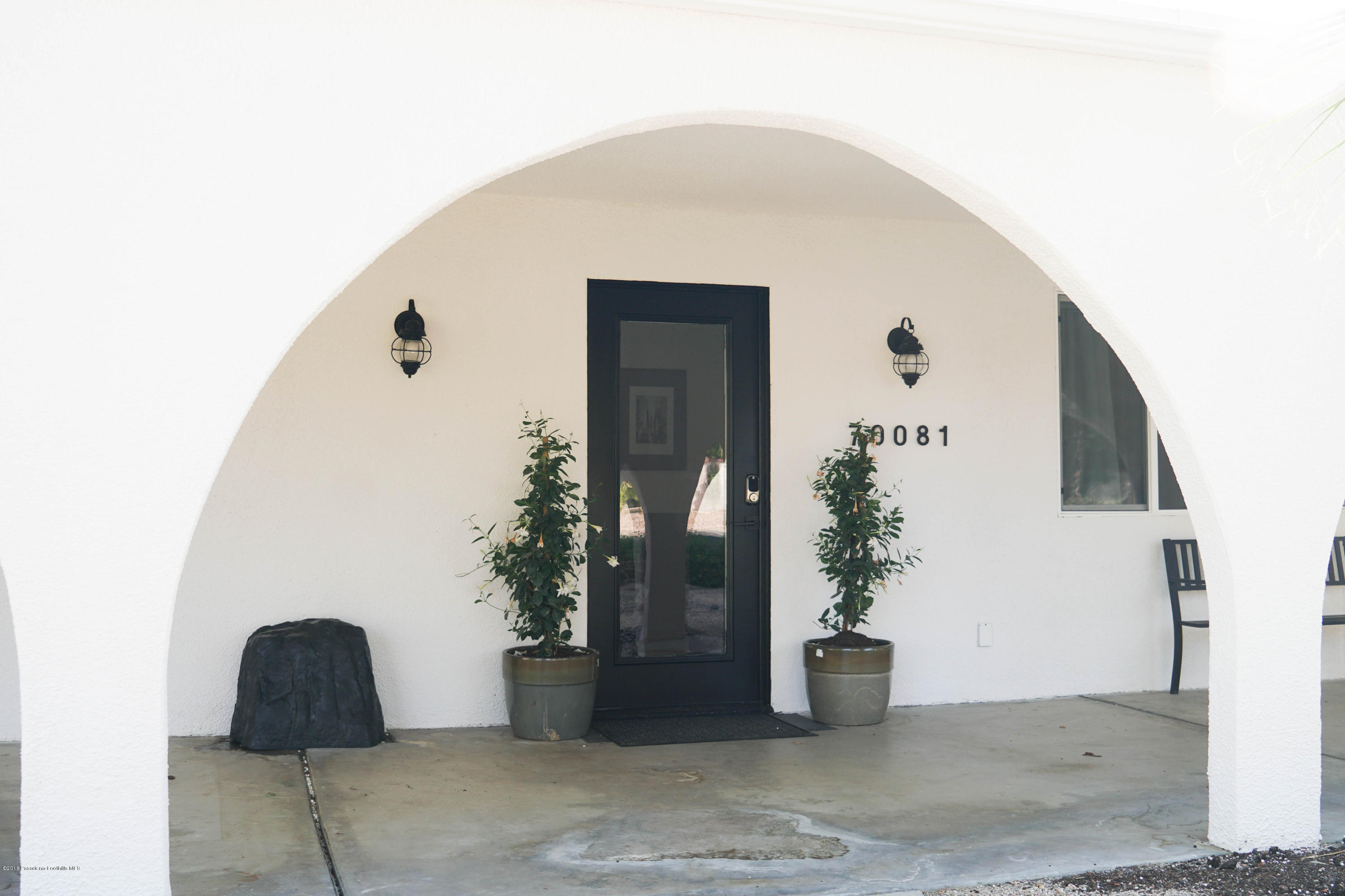 70081 Cobb Road Rancho Mirage, CA 92270 - Photo 3 of 17 a potted plant sitting in front of a door